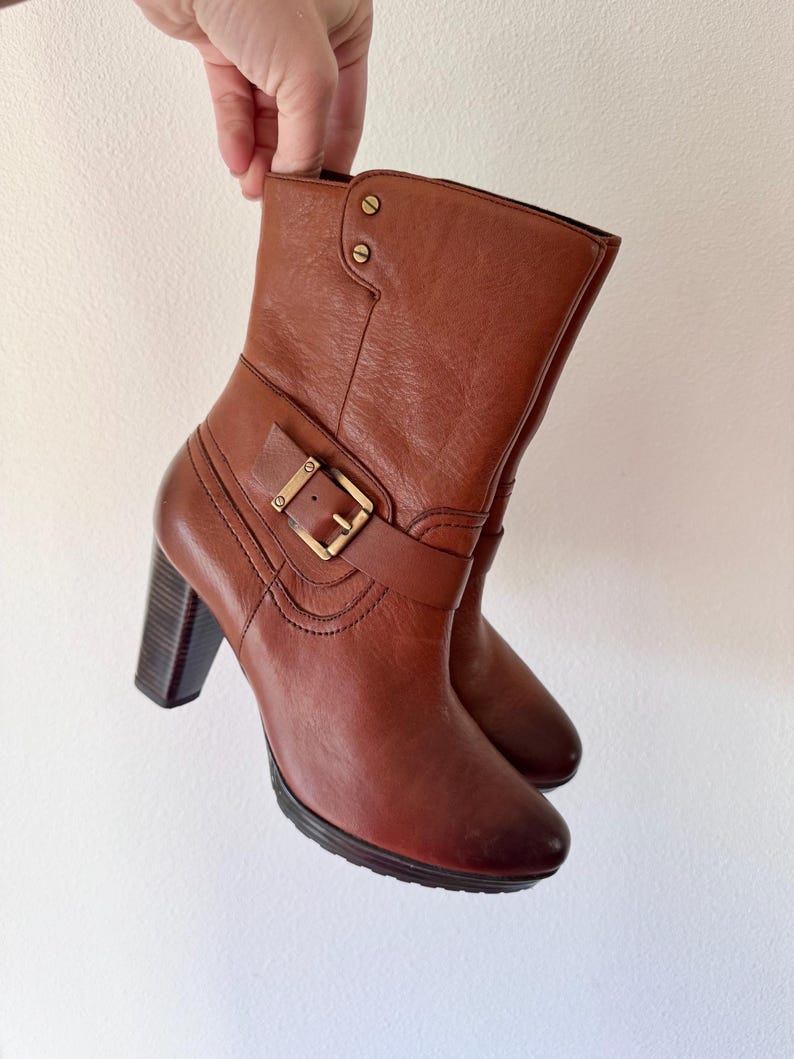 May include: A set of three ceramic mugs with a speckled, matte finish. The mugs are in shades of cream, light gray, and dark gray. Each mug has a simple, minimalist design, perfect for coffee or tea.