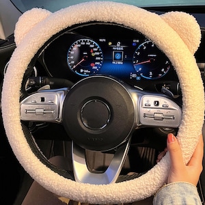 Puede incluir: Funda de volante de peluche blanca con orejas de oso. La funda está hecha de un material suave y afelpado y está diseñada para adaptarse a la mayoría de los volantes estándar.