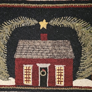 May include: A hand-hooked rug featuring a red house with a gray roof, flanked by two evergreen trees. A gold star sits above the house, and the background is black. The rug has a black border with a red and gold trim.