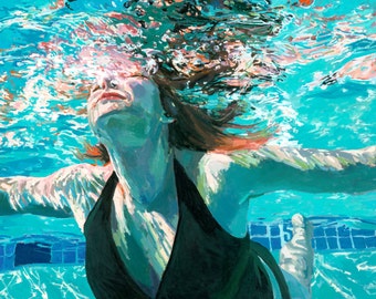 May include: A woman with long, red hair floats underwater in a swimming pool. The water is clear and blue, and the woman's face is visible. She is wearing a black swimsuit.