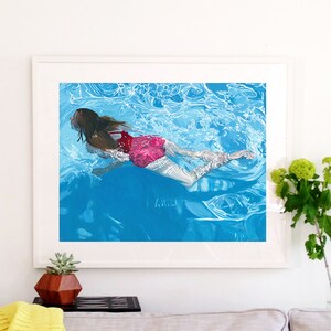 May include: A painting of a person swimming underwater in a pool. The person is wearing a pink swimsuit and has long brown hair. The water is blue and clear, and there are bubbles around the person.
