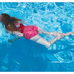 May include: A woman in a bright pink swimsuit swims in a blue pool. The water is clear and you can see the bottom of the pool. The woman's hair is brown and long. The light reflects off the water, creating a shimmering effect.