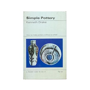 May include: A book titled "Simple Pottery" by Kenneth Drake. The cover features a blue background with a white vase and a blue and white plate. The text "How to make pottery without a wheel" is printed in black.