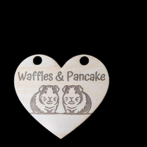 May include: Wooden heart-shaped tag with the text "Waffles & Pancake" and two guinea pigs engraved on it.