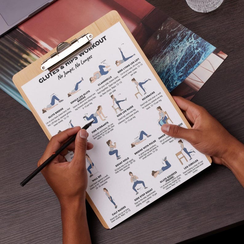 May include: A wooden clipboard with a printed workout guide for glutes and hips. The guide features illustrated exercises with instructions. A person's hands hold the clipboard and a pen, ready to take notes.