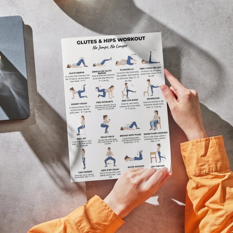 May include: A white printed workout guide titled "GLUTES & HIPS WORKOUT No Jumps, No Lunges." The guide features illustrated exercises for glutes and hips. The guide is held by a person wearing an orange shirt.