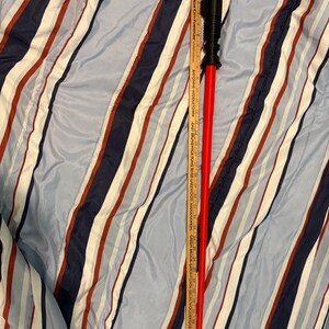 May include: A red and black lightsaber toy with a black handle and a red blade. The blade is about 30 inches long.