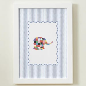 May include: A framed wall art piece featuring a white rectangular border with a wavy blue outline. Inside the border is a multi-colored patchwork elephant illustration. The background behind the central white panel consists of light blue vertical stripes.