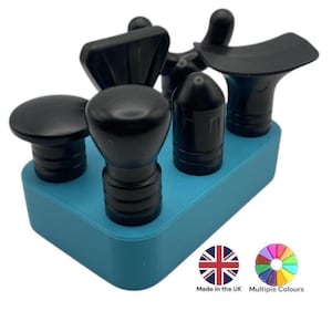 May include: A set of five black massage tools with different shaped heads, arranged in a blue plastic holder.  Made in the UK. Multiple colours available.