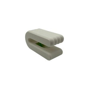 May include: A white, U-shaped object with a ribbed top and a smooth base. The design features a curved form with a space in the middle. The object appears to be made of a solid, matte material.