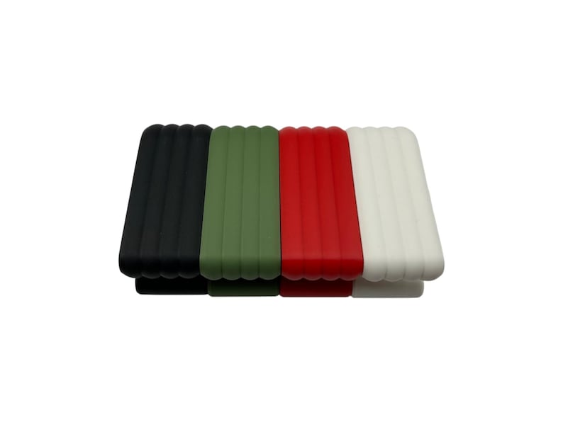May include: Four rectangular silicone watch bands in black, olive green, red, and white. Each band has a ribbed texture and a curved bottom edge. The bands are arranged side by side against a white background.