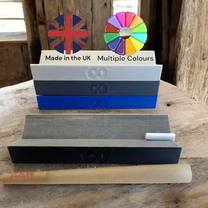 May include: A set of four rolling trays in black, grey, blue and white with an infinity symbol logo. The trays are made in the UK and are available in multiple colours. A rolling paper is also included.