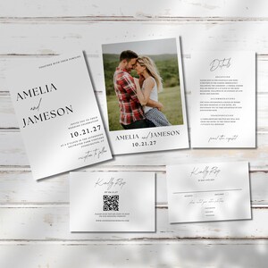 May include: A set of wedding stationery including a photo card, invitation, details card, and RSVP cards. The invitation and photo card feature the names "Amelia and Jameson" and the date "10.21.27". The cards are white with black text.