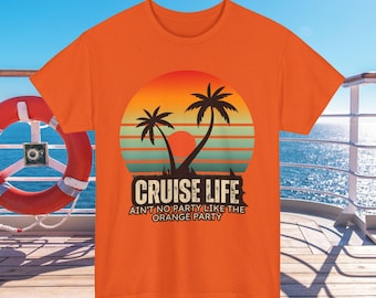 May include: Orange t-shirt with a graphic featuring a sunset, palm trees, and the words "CRUISE LIFE" and "AIN'T NO PARTY LIKE THE ORANGE PARTY". The shirt is displayed on a wooden deck with a life preserver and ocean in the background.