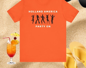 May include: Bright orange t-shirt with the text "HOLLAND AMERICA PARTY ON" and a silhouette of dancing figures. The image includes a cocktail with a decorative umbrella, sunglasses, and yellow flip-flops on a sandy surface.