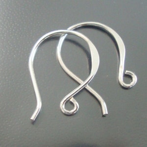 May include: Two silver earring hooks, each with a curved wire loop and a small, rounded hook at the end.