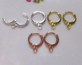 May include: Five earring hoops in different finishes: silver, gold, and rose gold. The hoops are all the same size and have a simple, classic design.