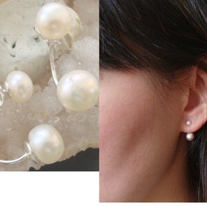 May include: A pair of pearl earrings with a silver hoop design. The earrings feature two pearls on each hoop, one larger pearl and one smaller pearl.