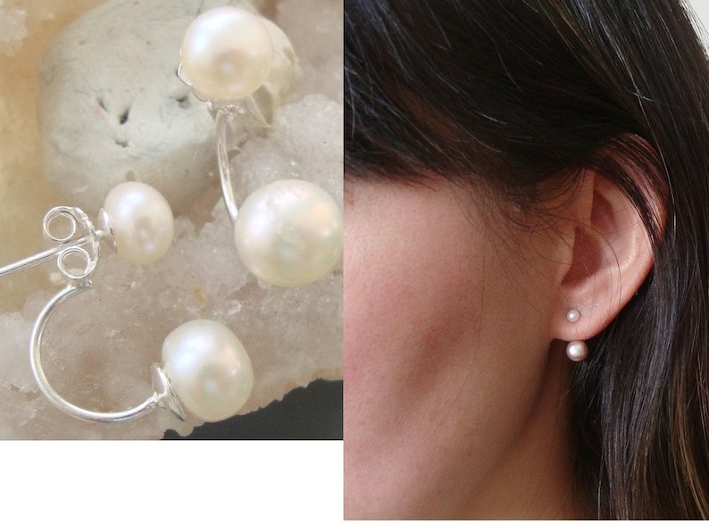 May include: A pair of pearl earrings with a silver hoop design. The earrings feature two pearls on each hoop, one larger pearl and one smaller pearl.