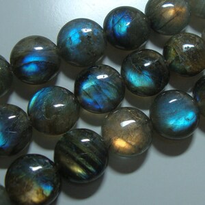 May include: A strand of round, iridescent labradorite beads with a blue-green sheen. The beads are smooth and polished, and they have a natural, organic look.