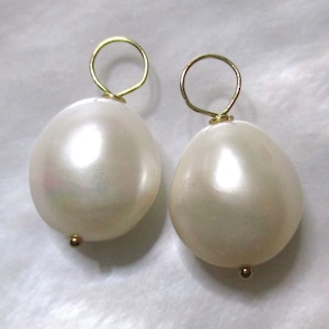 May include: Two white pearl earrings with gold jump rings.