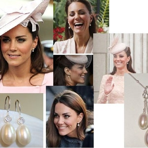 May include: A pair of silver drop earrings featuring a small clear crystal and a large white pearl. The earrings are displayed against a white backdrop.