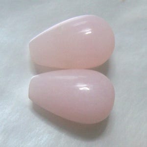 May include: Two teardrop-shaped pink opal beads.