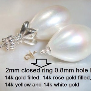 May include: Two white pearlescent teardrop-shaped beads with a 2mm closed ring and 0.8mm hole ID. The rings are available in 14k gold filled, 14k rose gold filled, 14k yellow gold, and 14k white gold.