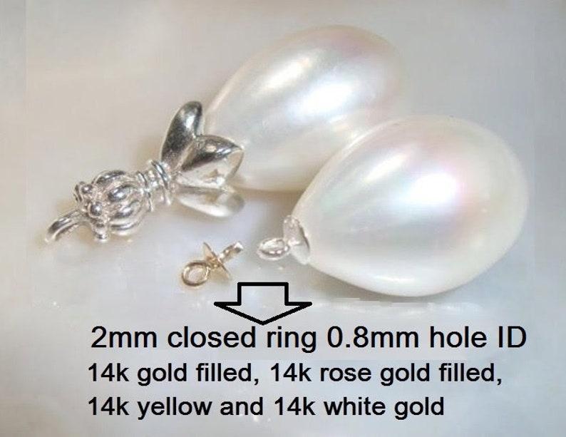 May include: Two white pearlescent teardrop-shaped beads with a 2mm closed ring and 0.8mm hole ID. The rings are available in 14k gold filled, 14k rose gold filled, 14k yellow gold, and 14k white gold.