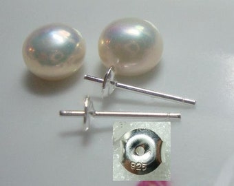 May include: A pair of white pearl earrings with silver posts and backs. The backs are marked with "925", indicating they are made of sterling silver.
