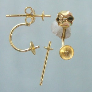 May include: Gold-toned earring findings with a post and a curved hook. The findings are designed to be used with a variety of earring styles.