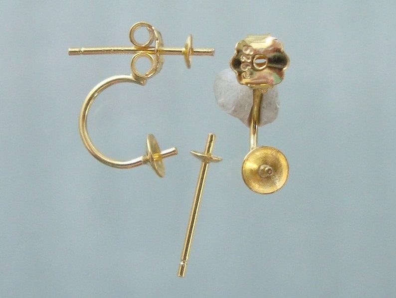 May include: Gold-toned earring findings with a post and a curved hook. The findings are designed to be used with a variety of earring styles.