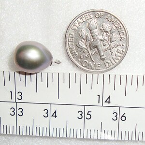 May include: A single, iridescent, gray pearl measuring approximately 13/16 inches in diameter. The pearl is next to a US dime for scale.