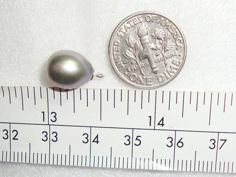 May include: A single, iridescent, gray pearl measuring approximately 13/16 inches in diameter. The pearl is next to a US dime for scale.