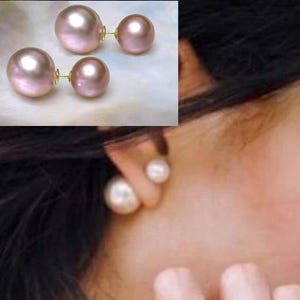 May include: Two pairs of pink pearl earrings with gold-colored posts. One pair is larger than the other. The earrings are displayed on a white surface, with one pair worn on an ear.