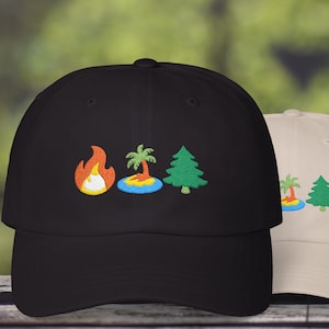 May include: Two baseball caps, one black and one beige, with embroidered designs. The black cap features a flame, a palm tree on an island, and a green tree. The beige cap has the same palm tree and green tree design.