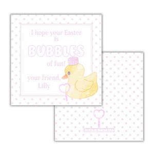 May include: A pink and white card with a yellow duck wearing a pink hat and holding a pink wand. The card says "I hope your Easter is BUBBLES of fun! your friend, Lilly".