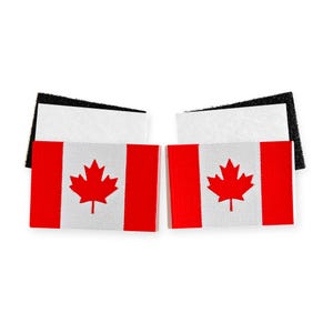May include: Two rectangular patches featuring the Canadian flag design with a central red maple leaf on a white background flanked by two red vertical bars. Each patch has a white fabric top edge and a black hook-and-loop fastener backing.