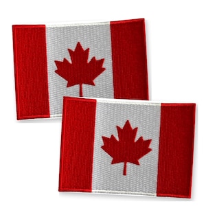 May include: Two rectangular embroidered patches featuring the Canadian flag design. Each patch displays a central white square with a red maple leaf and two vertical red bands on the left and right sides, showcasing a detailed fabric texture.