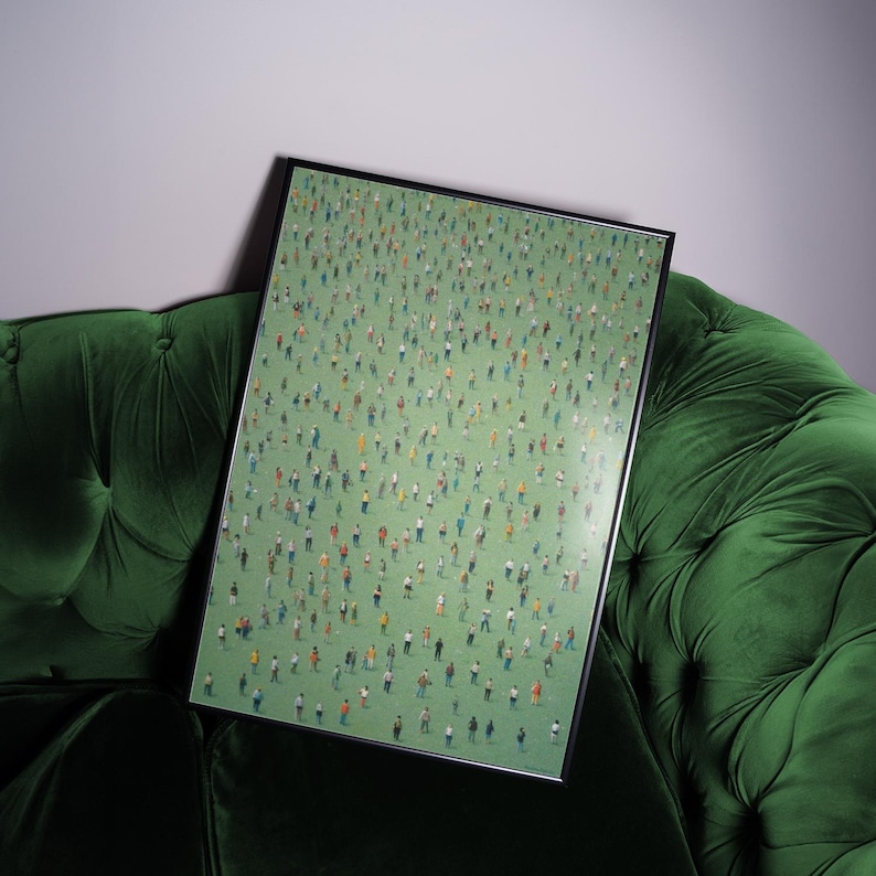 May include: A framed print of a painting depicting a large crowd of people standing on a green field. The people are painted in a variety of colors and sizes, creating a sense of movement and energy.