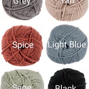May include: Six balls of yarn in different colors: grey, tan, spice, light blue, sage, and black.