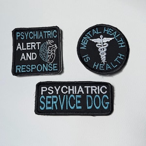 May include: Three black embroidered patches with light blue and white text. One square patch reads PSYCHIATRIC ALERT AND RESPONSE with a brain icon. One circular patch reads MENTAL HEALTH IS HEALTH with a caduceus. One rectangular patch reads PSYCHIATRIC SERVICE DOG.