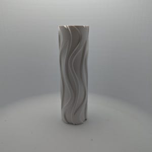 May include: A cylindrical white vase featuring a continuous vertical wave pattern embossed along its exterior surface. The object has a matte finish and a uniform color throughout, with a hollow opening at the top and a flat base for stability.