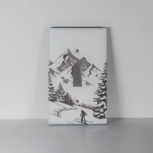 Winter alpine mountain scene with fresh snow and a skier