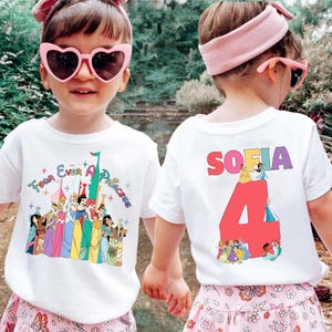 May include: White t-shirt with a colorful graphic featuring Disney princesses and the text "Four Ever A Princess." The back of the shirt displays the name "Sofia" above a large number "4" with more princess illustrations.