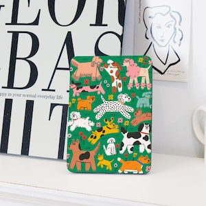 May include: A green phone case featuring a pattern of colourful dogs on a green background. The dogs are all different breeds and sizes, and they are all smiling.