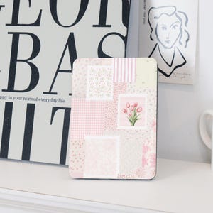 May include: Pink and white patchwork coaster featuring a floral design and a bunch of pink tulips in the centre.