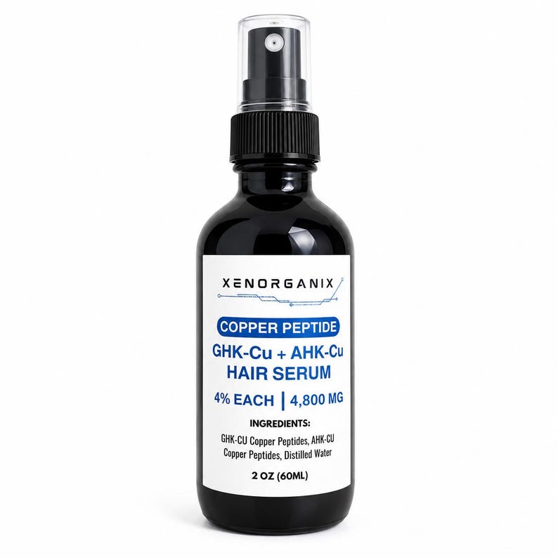 May include: A black glass spray bottle containing Xenorganix Copper Peptide GHK-Cu + AHK-Cu Hair Serum. The white label displays the product name, 4% each, 4,800 mg, ingredients list, and a volume of 2 oz. The bottle has a black pump and clear cap.