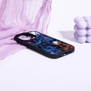 May include: Black phone case with a colorful illustration featuring a person, buildings, and other elements. The case has a black border and a cutout for the camera. The design is set against a dark blue and purple background.