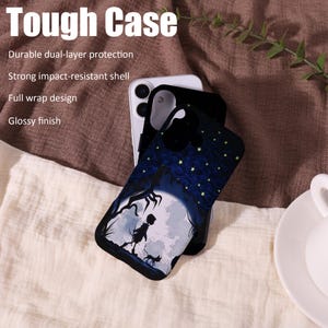 May include: A black phone case with a whimsical design featuring a silhouette of a person, a cat, and a full moon. The case has a starry night sky pattern and the text "Tough Case".